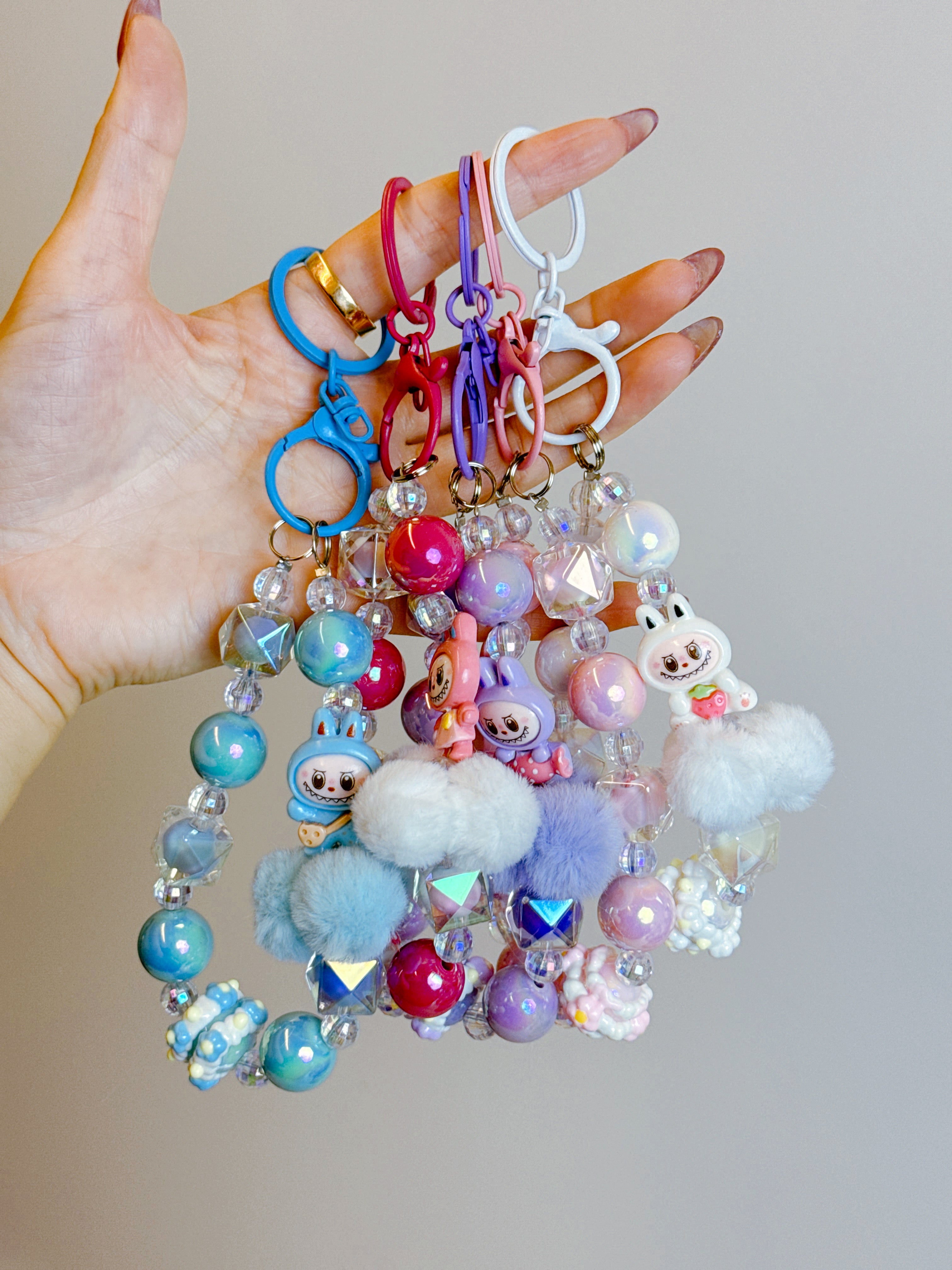 Labubu Phone Chain – Beaded Wrist Strap with Fluffy Pom-Pom & Resin Mini-Doll Charm